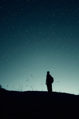 Wall Mural - stars on the night sky and man silhouette star gazing, night landscape