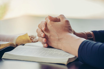 Prayer and bible concept. Caucasian men praying, hope for peace and free from coronavirus, Hand in hand together by businessman, believes and faith in christian religion at church.
