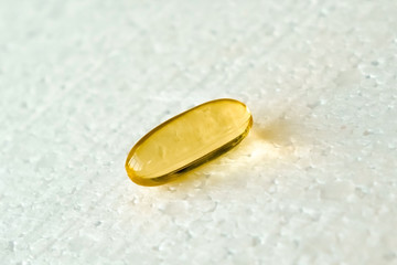 Wall Mural - One capsule of vitamin omega 3 lies on a white background.