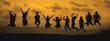 © chokniti - The black silhouette of a large group of people jumping together with joy On the occasion of the celebration of the team's success The atmosphere of the sunset means success in work.