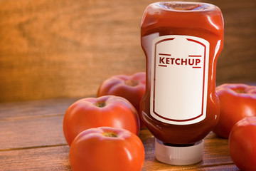 Ketchup sauce with many tomatoes around on brown wooden board