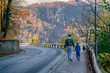 Father and son walk by the road near forest in Bled, Slovenia
