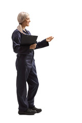 Poster - Female worker in an overall uniform holding a clipboard and gesturing with hand