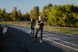 © shchus - Parents and children spend time together. Older generation and sport. Active lifestyle of the pensioner. Happy old man riding on rollers with his daughter on the road in autumn park.