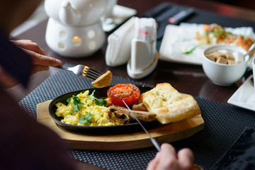 man is having a traditional english breakfast in a diner