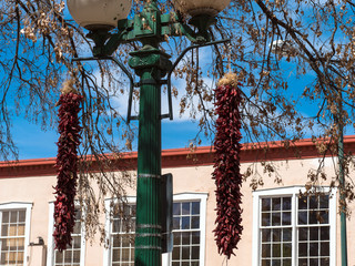 Poster - Traditional lamppost, two chile ristras, and an historic public building on the Plaza at Santa Fe, New Mexico