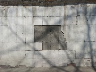 Old white wall of the building from the side of the street