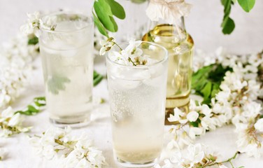 Sticker - acacia flowers drink. lemonade with a syrup of white acacia flowers. Edible flowers.