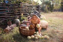 Little Boy Playing With Apples And Pumpkins