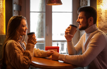 Sticker - Young couple drinking coffee in cafe