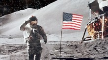 Animation Of An Astronaut In Space Standing On The Moon With American USA Flag , Surrounded By Stars From Moon Landing Apollo Mission. Contains Public Domain Image By NASA