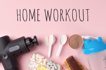 Wall Mural - Home workout, lockdown. Therapeutic percussive massage gun, fit meal, pills, sport energy bar on pink background - concept of modern sport activity and diet, lifestyle routine, wellness, healthcare