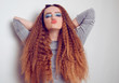 © MoreThanProd - Girl with curled voluminous hair, model with hairstyle in the style of the 80s. 90s, with bright blue make-up. Hair care, brunette red-haired girl with long hair, curling curls, corrugation hair