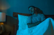 © TheVisualsYouNeed - dramatic portrait in the dark of attractive depressed and worried man on bed suffering depression crisis and anxiety feeling lost sitting sleepless in insomnia and life problem concept
