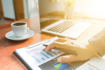 Wall Mural - businessman working with modern workplace with laptop on wood table, Man hand on laptop keyboard for work from home, Overhead view of businessman working  in office