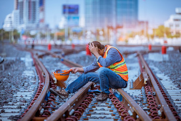 Wall Mural - Portrait engineer under inspection and checking construction process railway switch and checking work on railroad station .Engineer wearing safety uniform and safety helmet in work.