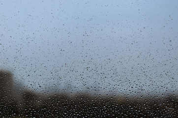 Wall Mural - Rain drop on glass window in monsoon season for abstract and background concept.
