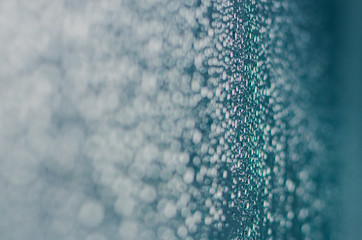 Wall Mural - Blurred and focus of rain drop on glass window in monsoon season for abstract and background concept.