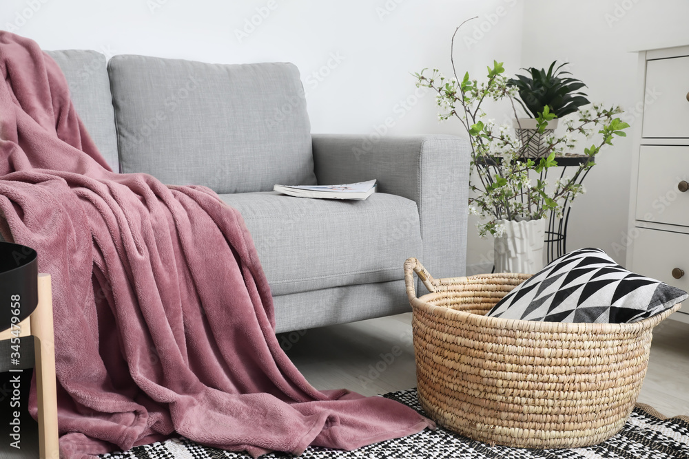 Sofa with warm plaid in interior of room
