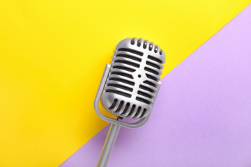 Retro microphone on color background