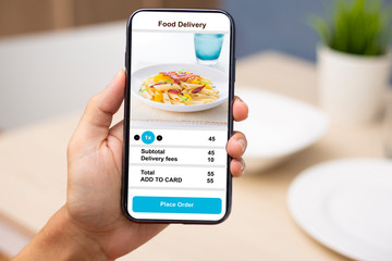 holding phone with application delivery food online