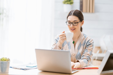 woman working on a laptop at home.