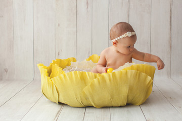 Wall Mural - Little girl sitting in handmade paper cabbage on wood background. Backdrop. One year birthday decoration. Inspiration for baby photo. Paper art and cut.