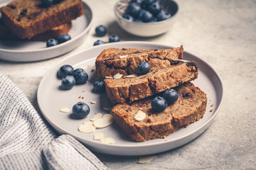 Wall Mural - Slices of banana bread with berries on gray plate. Healthy vegan food concept.