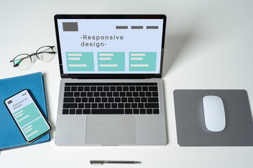 Responsive web design on laptop, tablet computer and mobile phone with clipping path from above..