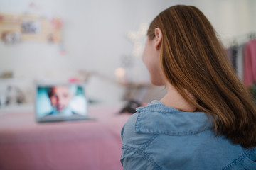 Wall Mural - Beautiful happy young girl with laptop sitting and smiling, online dating concept.