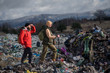 © Halfpoint - Man and woman hikers on landfill, environmental concept.