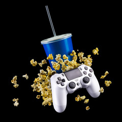 Wall Mural - Blue cup with cap and flying popcorn isolated on black background