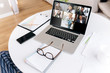 © Kateryna - Video call. Online zoom conference. Business team gathered for an online meeting in zoom app. On a laptop monitor a group of people in online meeting