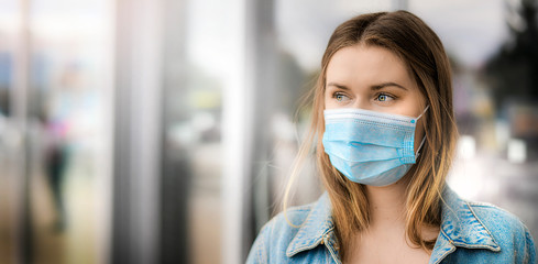 Woman in face mask copy space for text. Coronavirus flu epidemic travel of the city concept wide banner panorama