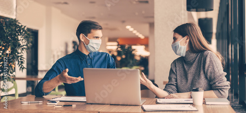 Cuadros en Lienzo business colleagues in protective masks sitting at the office Desk