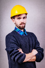 serious young man in a yellow helmet