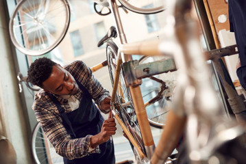 Craftsman In Workshop Assembling Hand Built Sustainable Bamboo Bicycle Frame