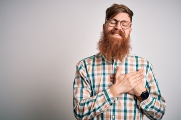 Sticker - Handsome Irish redhead man with beard wearing glasses and hipster shirt smiling with hands on chest with closed eyes and grateful gesture on face. Health concept.