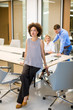 © BGStock72 - Young african american woman standing  in a modern office