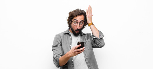 Poster - young crazy cool man using his smartphone against white wall