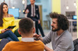 © qunica.com - Businessman with afro haircut casual dress code working in modern offices, talking to his mixed-race colleagues