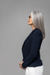 © LIGHTFIELD STUDIOS - side view of asian businesswoman with grey hair in eyeglasses isolated on grey