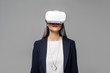 © LIGHTFIELD STUDIOS - attractive businesswoman using virtual reality headset isolated on grey