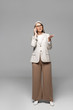 © LIGHTFIELD STUDIOS - asian businesswoman with grey hair talking on smartphone on grey