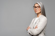 © LIGHTFIELD STUDIOS - attractive asian businesswoman in eyeglasses with crossed arms isolated on grey
