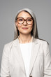 © LIGHTFIELD STUDIOS - attractive confident asian businesswoman in eyeglasses isolated on grey