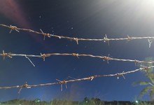 Low Angle View Of Barbed Wires Against Blue Sky