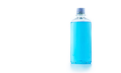 Wall Mural - transparent blue alcohol in big bottle in white background