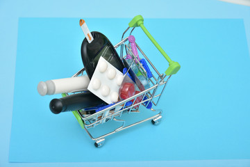 Shopping cart with digital glucometer, lancet pen and syringes and pills, medicines