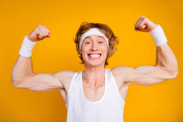 Sticker - Close-up portrait of his he nice attractive cheerful cheery content sportive guy sportsman showing muscles motivation success isolated over bright vivid shine vibrant yellow color background